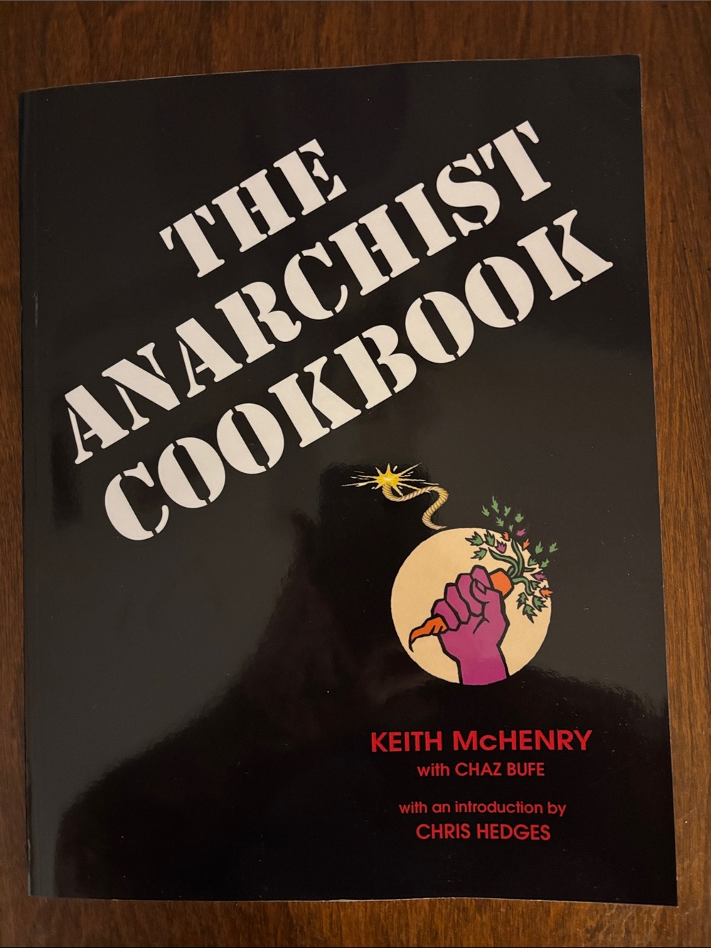 The Anarchist Cookbook paperback - black cover with pink fist artwork